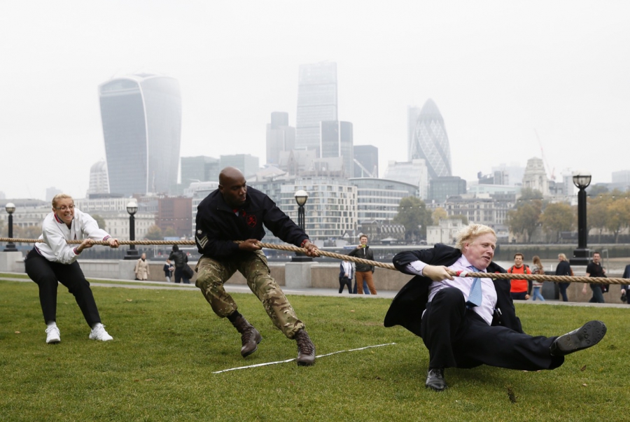 Then-Mayor Boris Johnson took part in a tug of war with members of the armed services to launch the London Poppy Day, outside City Hall, in London, on Oct. 27. Then-Mayor Boris Johnson took part in a tug of war with members of the armed services to launch the London Poppy Day, outside City Hall, in London, on Oct. 27.